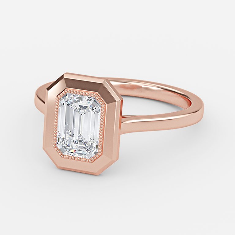 bezel setting engagement ring with emerald stone